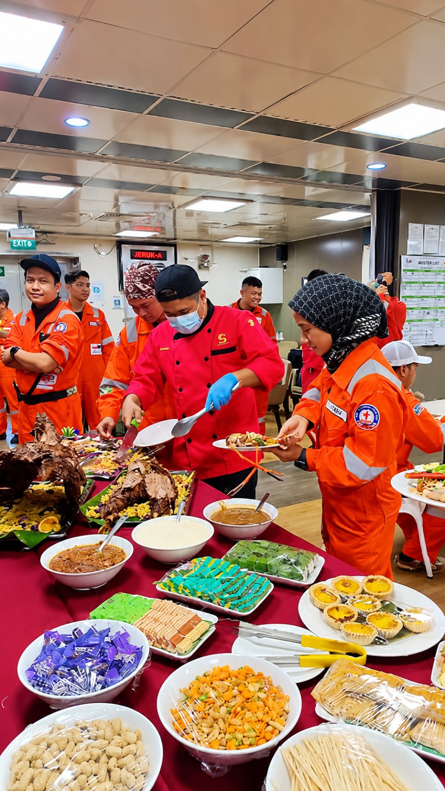 Galley crew serving the buffet to offshore crew in coveralls